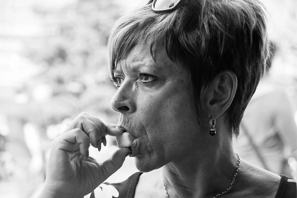 Thoughtful Woman Enjoying a Snack in Black and White
