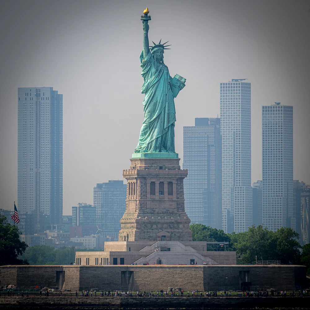 Iconic Statue of Liberty Against New York City Skyline