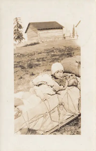 Canadian prairie child on sled by Stuart Alexander...