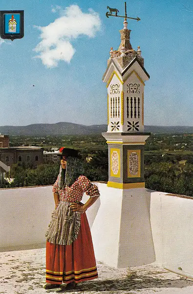 A typical chimney with traditional lady (!) Algarve,...