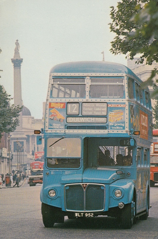 Routemaster bus in Whitehall with blue advertising livery