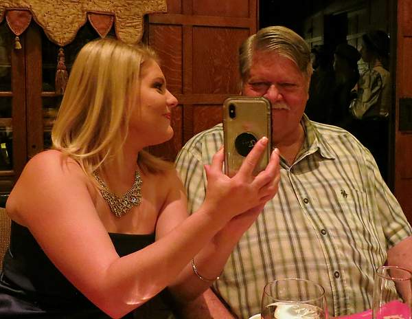Granddaughter Shyanne showing photo to Grandpa Bergeron...