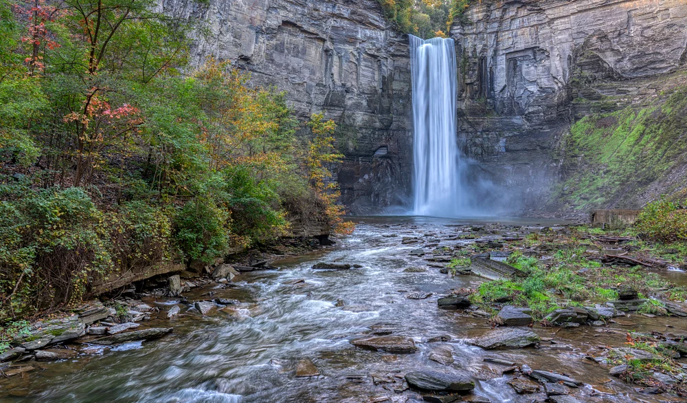 Majestic Waterfall Viewed from the Riverbank