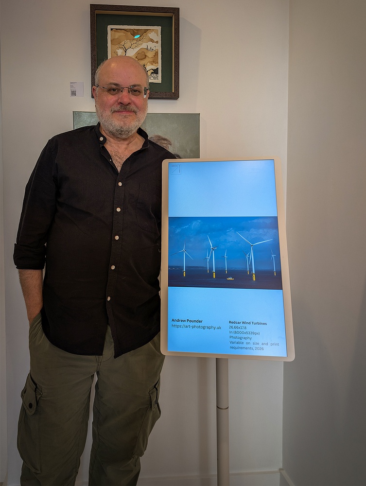 Andrew Pounder with "Redcar Wind Turbines" exhibition image