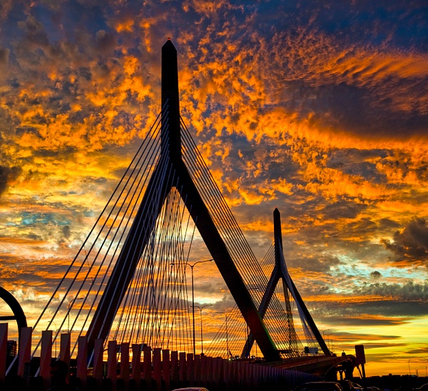Clouds and sunset over the Zakim Bunker Hill Bridge, Interstate I 93, over the Charles River in Boston, MA by Rick F Friedman - Rick Friedman Photography