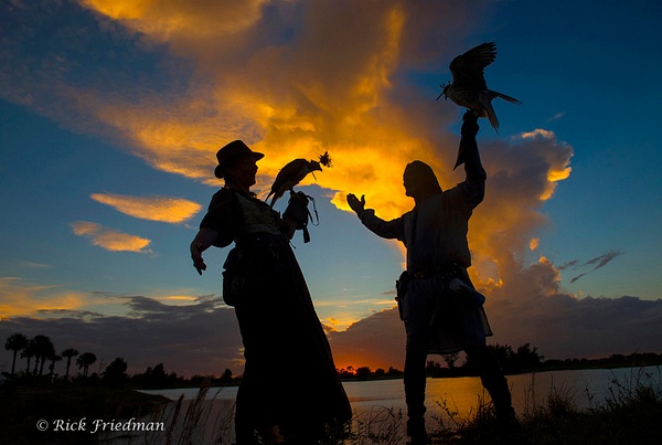 Silhouetted falconers in central  Florida by Rick Friedman - Rick Friedman Photography 