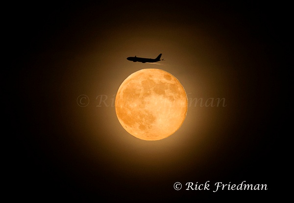 Jet plane appears to fly above the rising full moon, north of Boston - Rick Friedman Photography