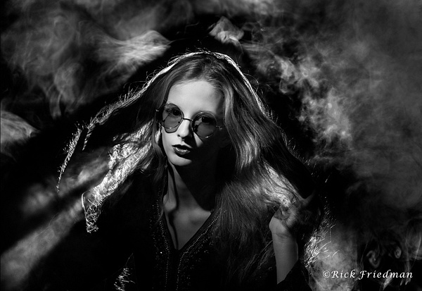 Model with long blond hair surrounded by smoke in black and white by Rick Friedman - Rick Friedman Photography