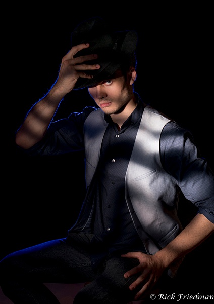 Male model wearing vest and black hat in shadows by Rick Friedman - Models - Rick Friedman Photography