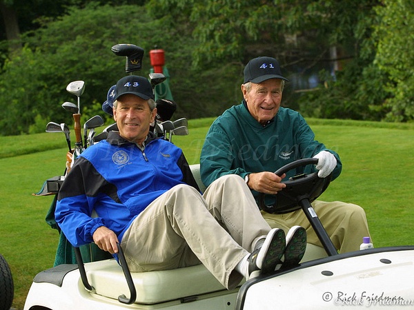 President George HW Bush and  President  George Bush  in a gold cart  at Cape Arundle Country Club - Politics - Rick Friedman Photography