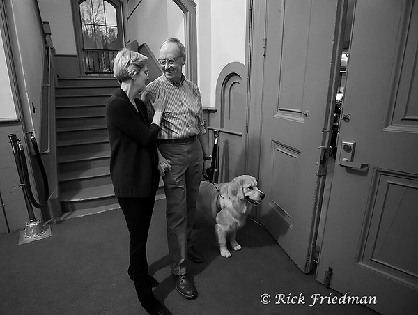 US Senator Elizabeth Warren with husband  Harvard Bruce Mann and  dog Bailey waiting outside campaign event by  Rick  Friedman - Politics - Rick Friedman Photography 