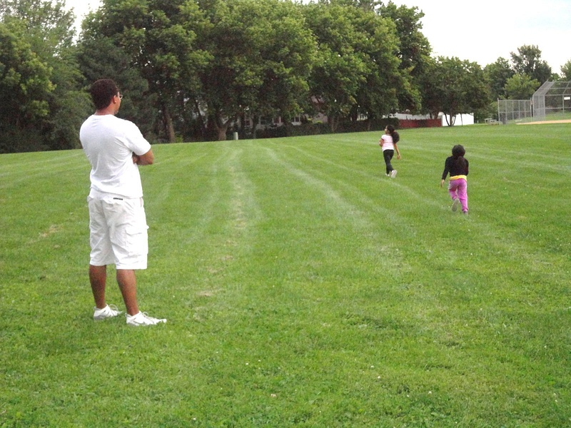 Daddy watching his little girls run.