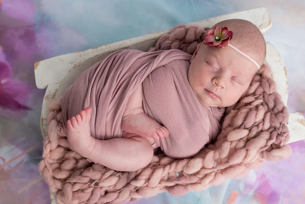 Adorable Newborn Wrapped in Soft Fabrics
