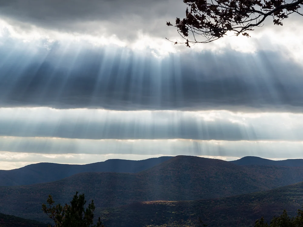 Radiant Beams Illuminating Mountainous Horizons