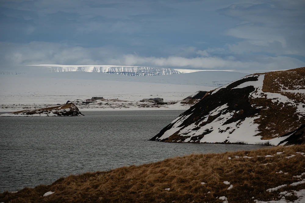 Tranquil Lake Scene with Snowy Mountains in Distance