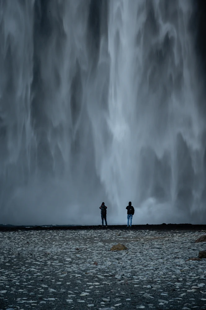 Enchanting Skogafoss Waterfall with Silhouetted Figures