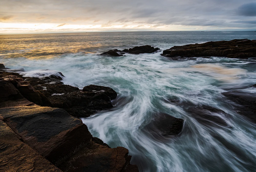 Dramatic Sunrise Over Rocky Coastline