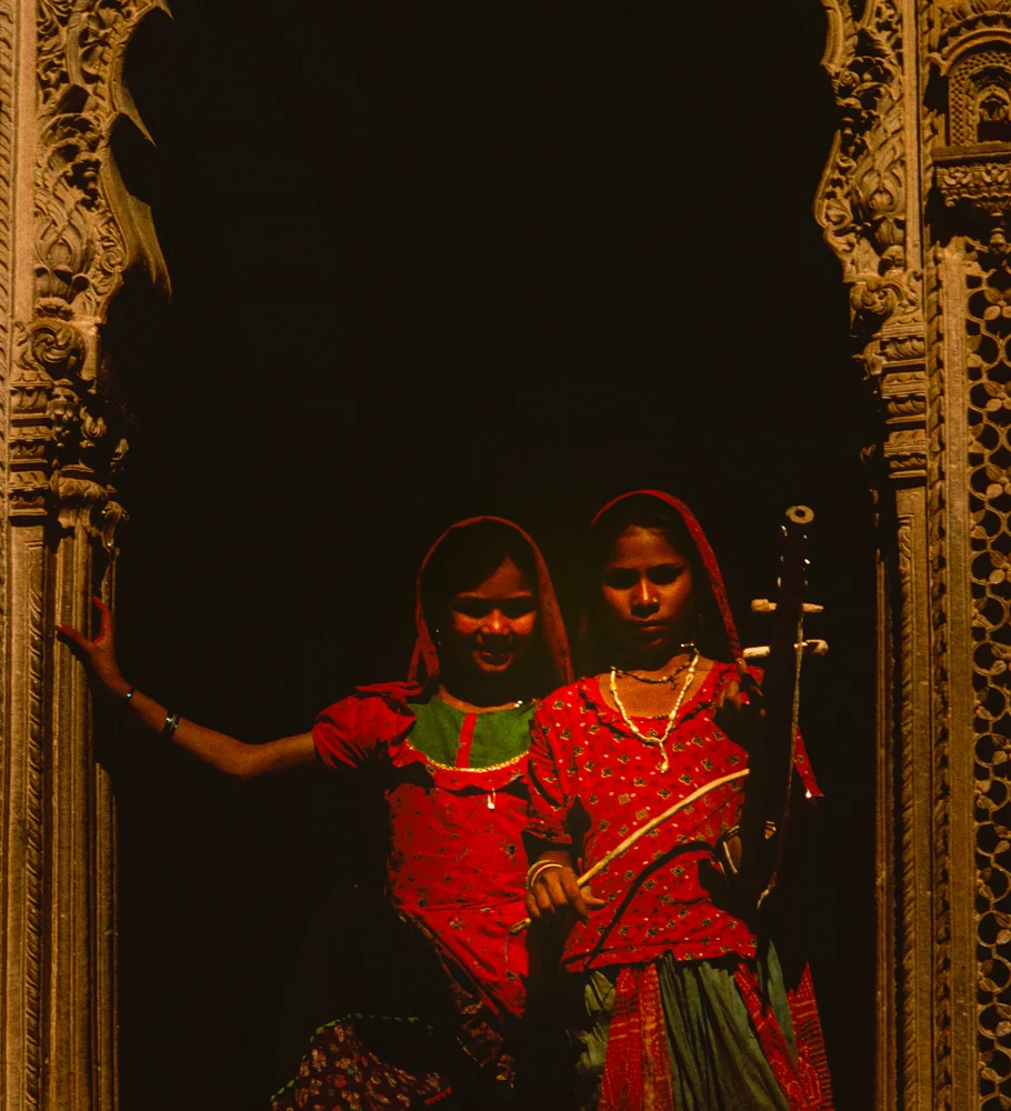 Charming Girls Posing in Jaisalmer's Ornate Window