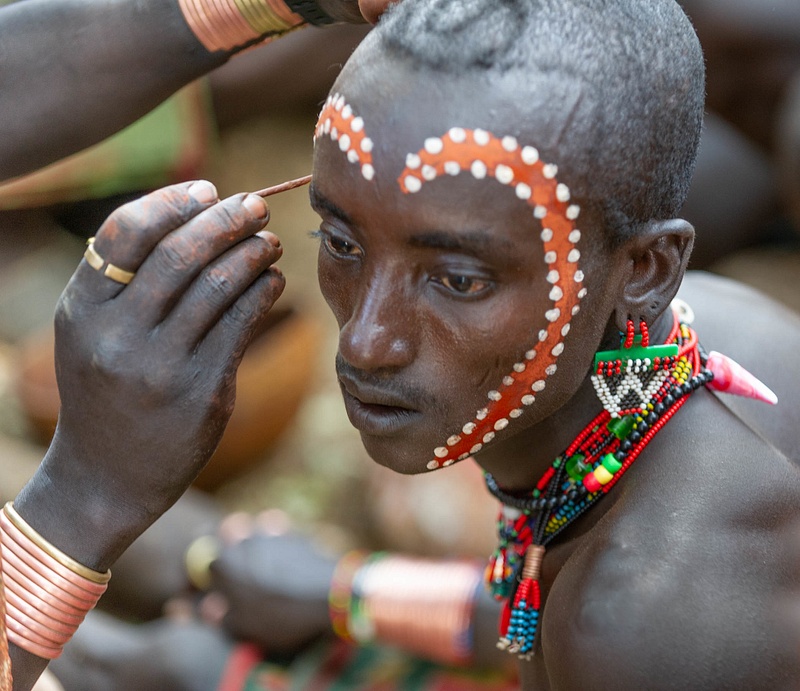 A male of the Hamar (Hamer) tribe having his face painted, before an important ceremony, Ethiopia