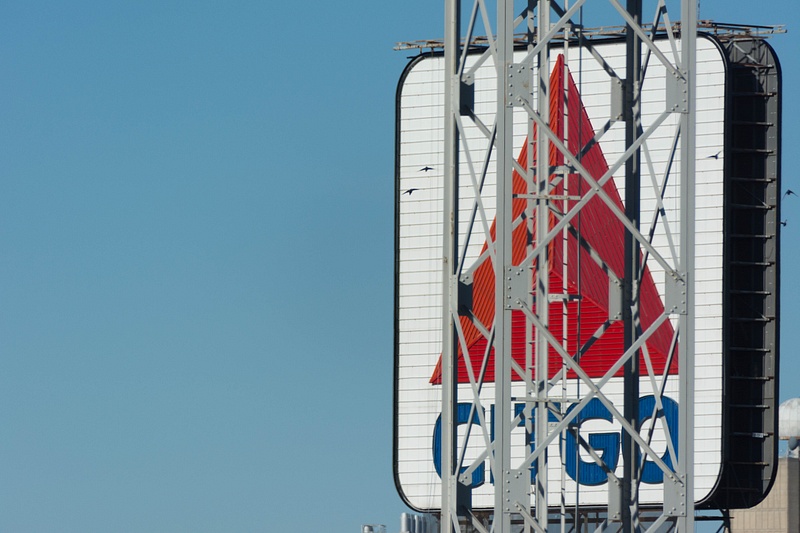 Iconic Boston Citgo sign seen through one of the light towers at Fenway Park