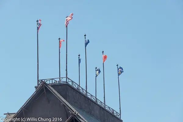 Flags on the roof of the Old Faithful Inn by Willis Chung