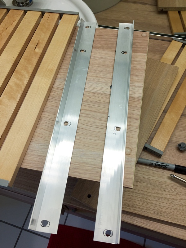 Two aluminum angles used to attach the front of the top drawer to the front of the bottom drawer.