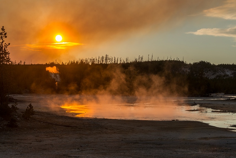 Steam, smoke, setting sun, Tantalus Creek, Norris Geyser Basin, Yellowstone National Park, Wyoming.