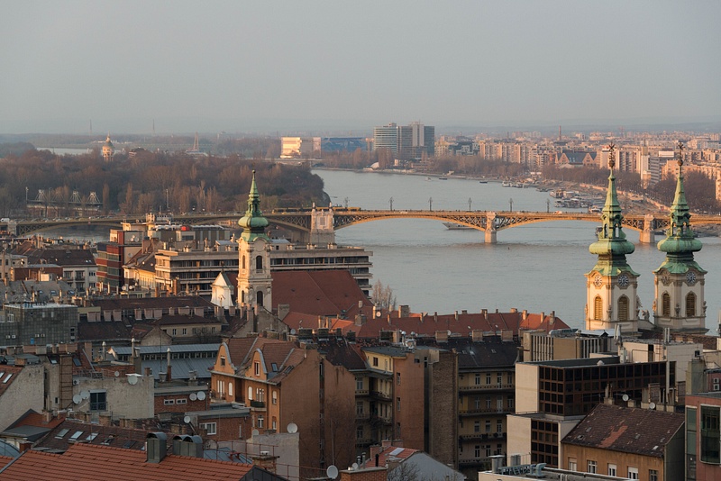 Margit híd, Margaret Bridge, and the churches on the west bank of the Danube at sunset.