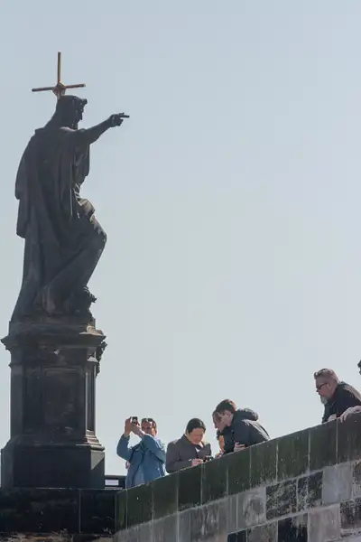 Statue on Charles Bridge looks to be giving  photography...