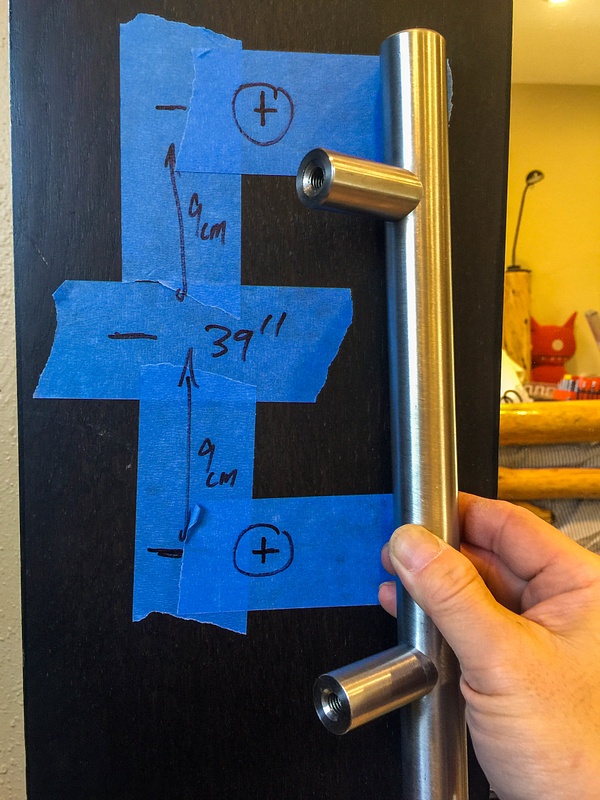 Marking holes for tubular steel barn door handle. Mix of English and Metric measurements.
