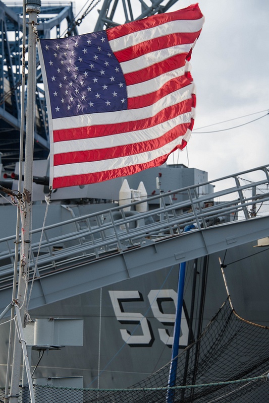 Flag in the fantail of the Joe Kennedy, looking at the stern of the USS Massachusetts.