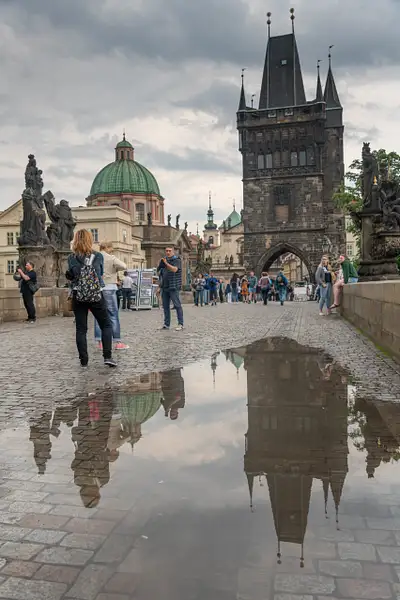 Old Town Bridge Tower and puddles after thunderstorm. by...