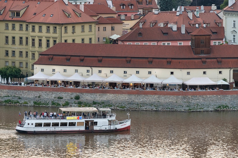 Cruising in the twilight on the Vltava. Mala Strana busy with diners.