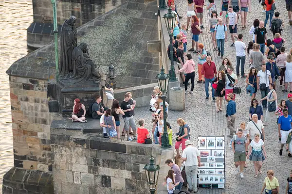 Tourists in the twilight on the Charles Bridge. by...