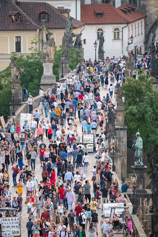 A few people out for a twilight stroll on the Charles Bridge.