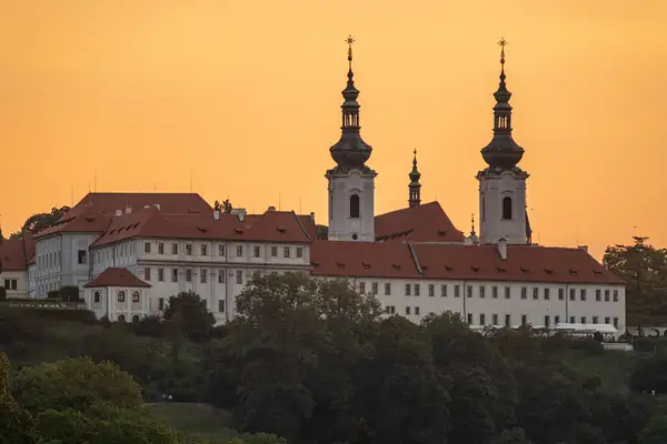 Twilight sun behind the Strahov Monastery next to Petrin...