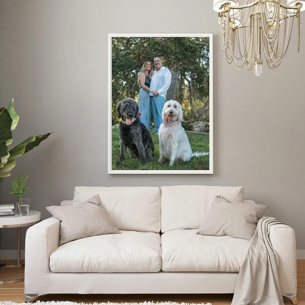 family portrait with dogs framed over couch