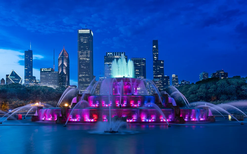 Illuminated Fountain Show Against City Skyline