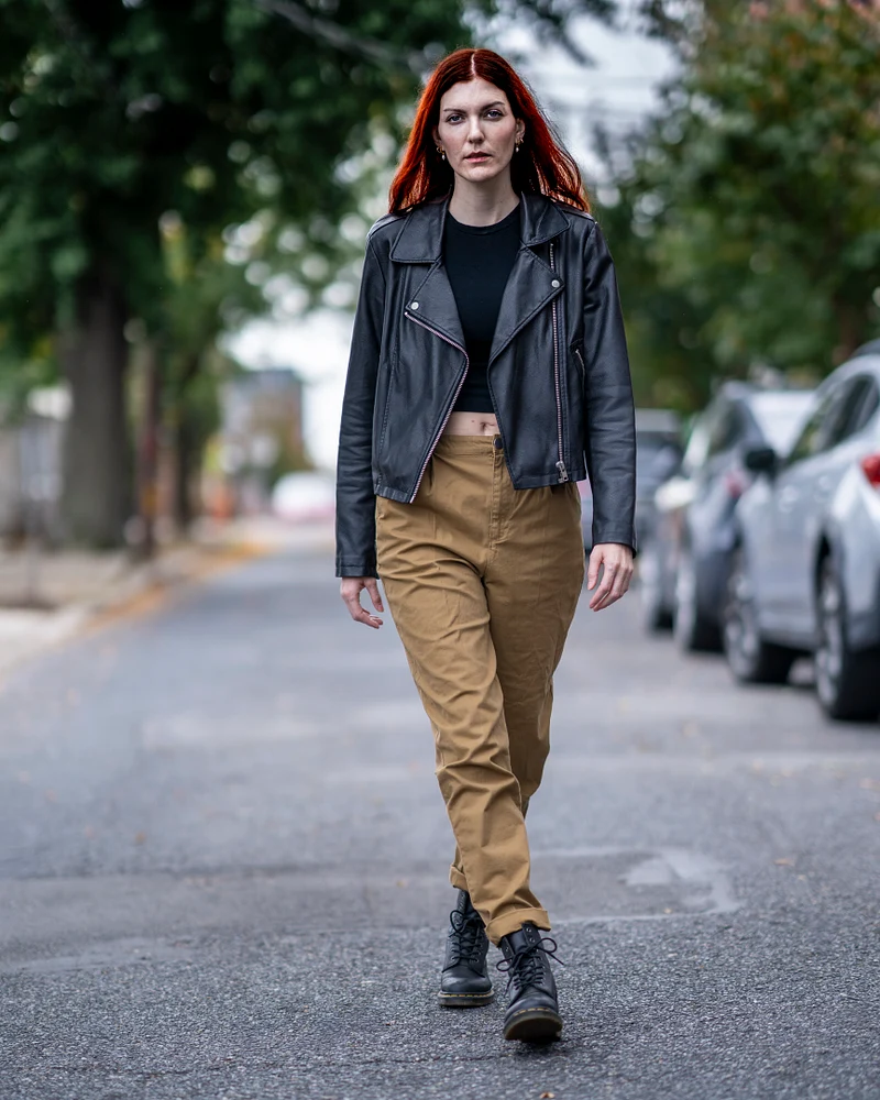 Confident Walker Strides Through Urban Street