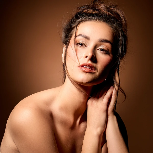 Elegant beauty portrait  with soft lighting and warm background.