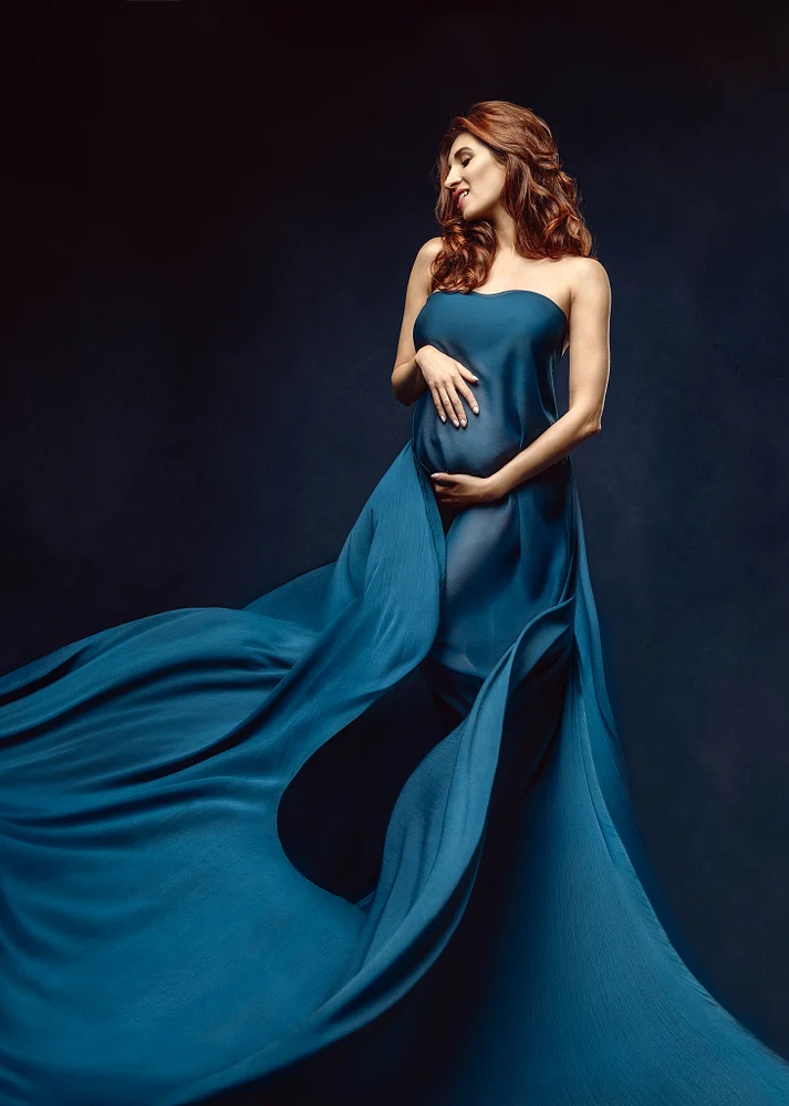 Elegant Maternity Portrait with Flowing Fabric