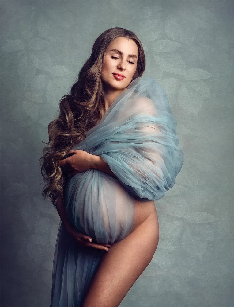 Elegant Maternity Portrait with Flowing Fabric