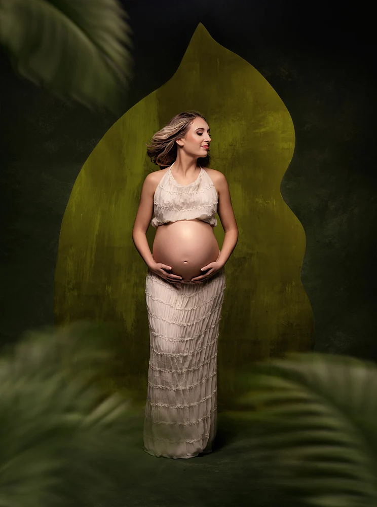 Elegant Maternity Portrait with Leaf Backdrop