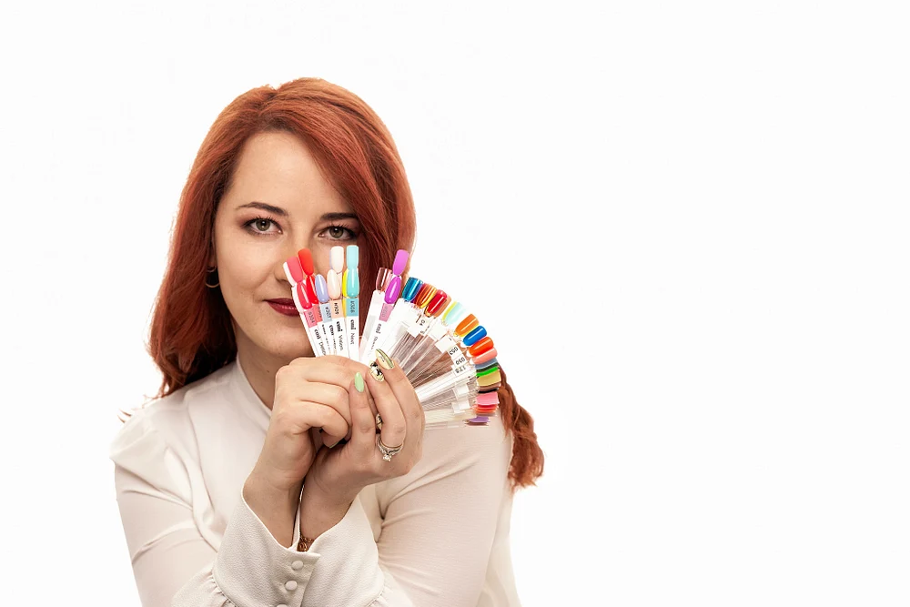 Woman Showcasing Colorful Nail Polish Swatches