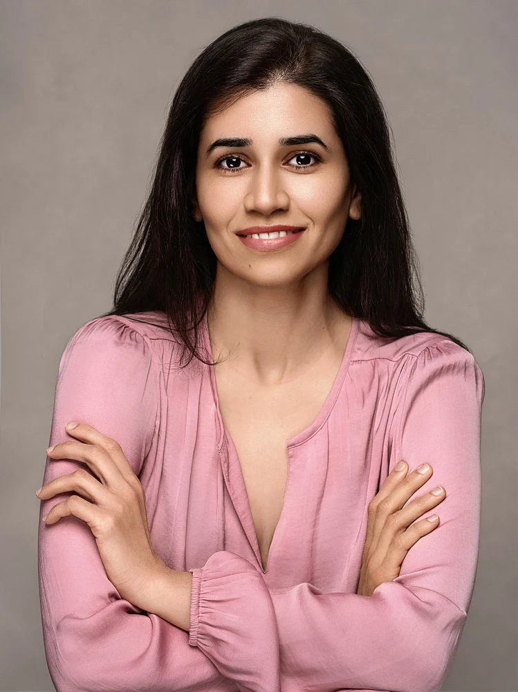 Professional Portrait of a Smiling Woman in Soft Pink Blouse