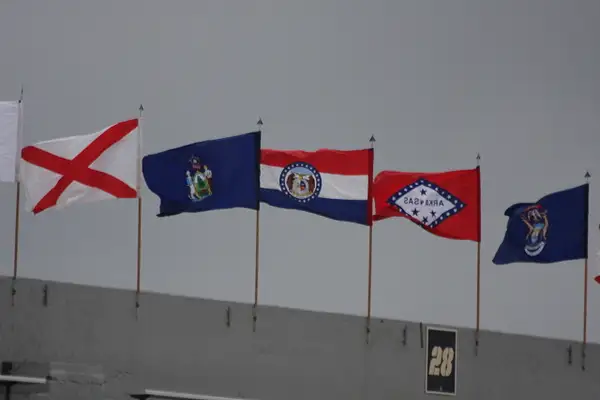 The flags of every state snap in the brisk wind over...