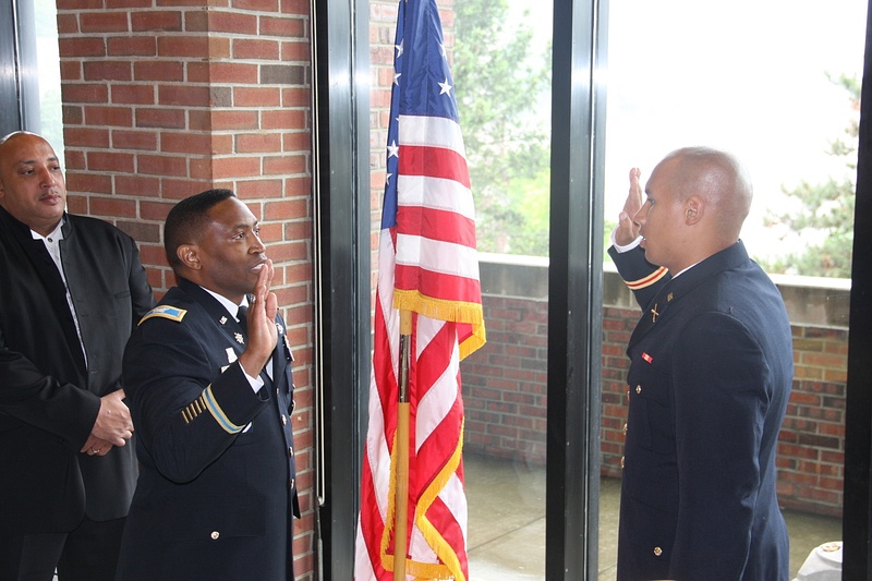 As proud father TG Cunningham look on, COL Williams administers the oath for 2nd LT Cunningham