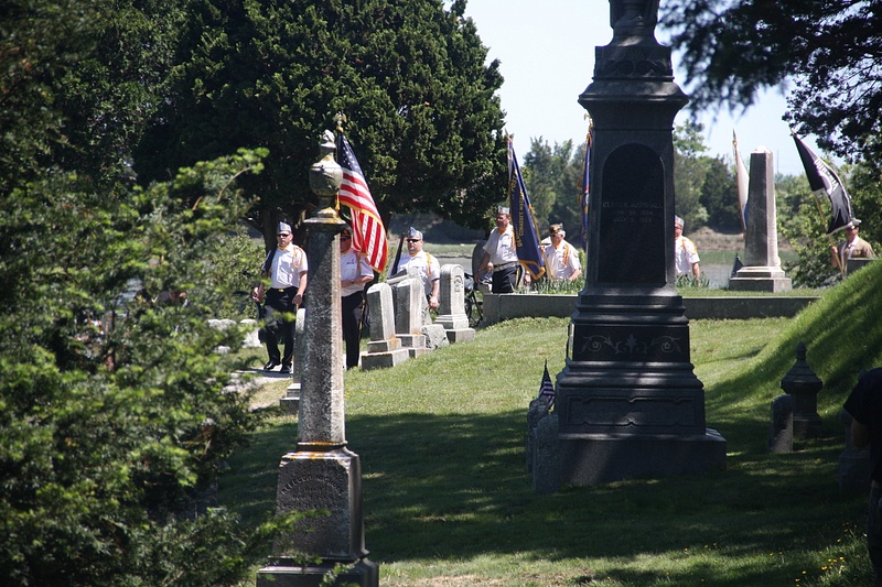 The parade moves through Cohasset Central Cemetery