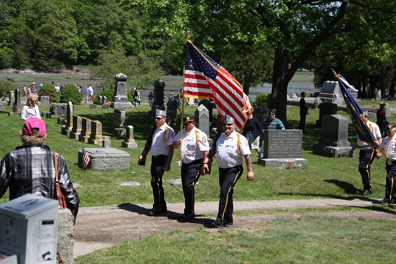 The parade moves through Cohasset Central Cemetery with the VFW Honor Guard in the lead