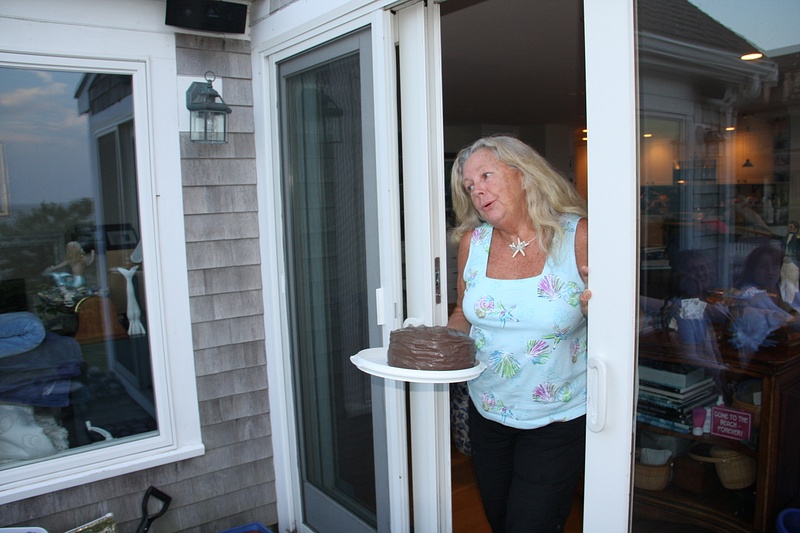 Liz delivering a fake birthday cake